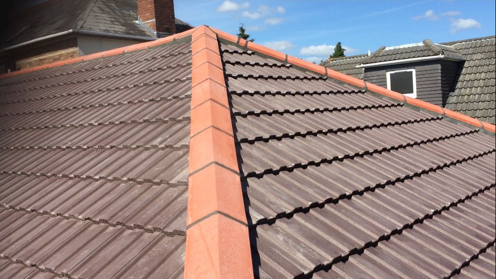 Tiled roof with orange ridge tiles