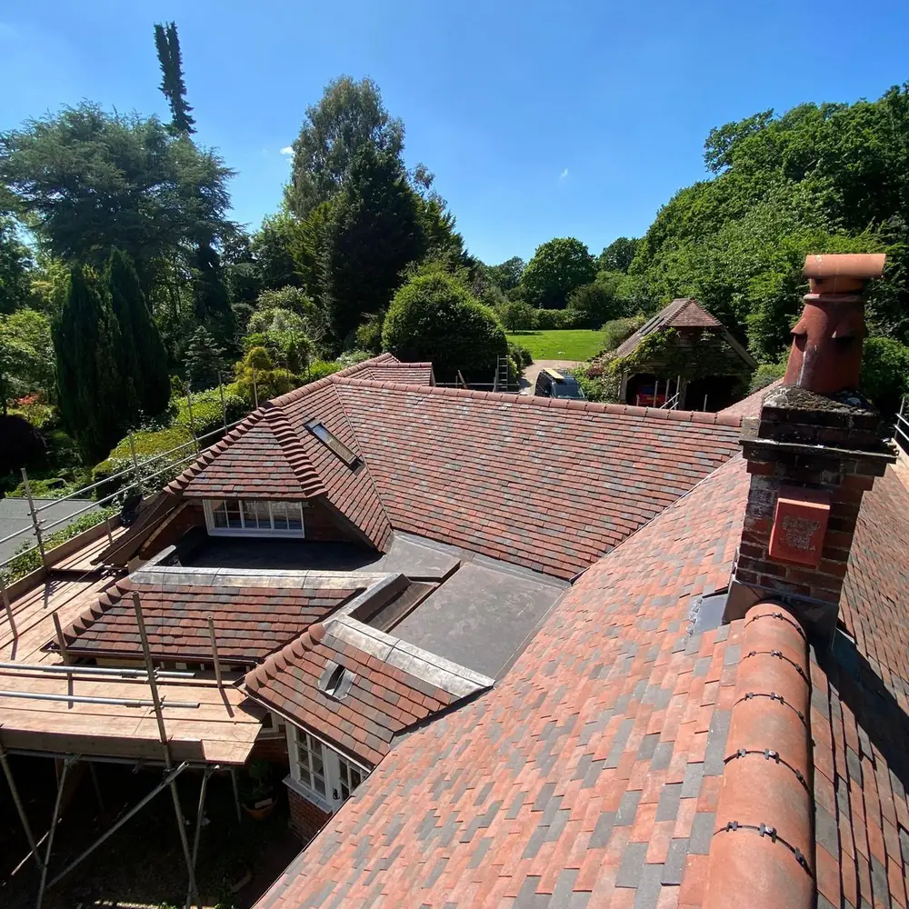 Red clay tiled hipped roof with chimney