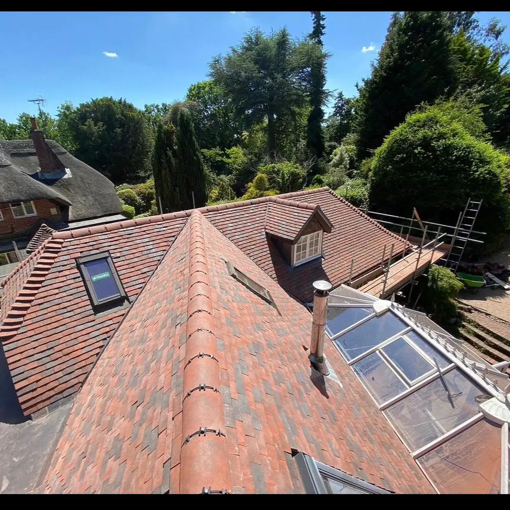 Red clay tiled roof with dormers and skylight